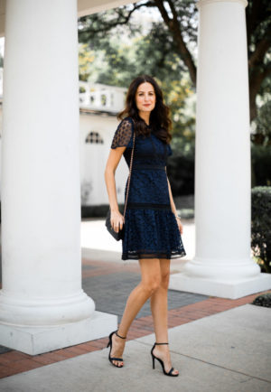 the miller affect wearing a navy lace dress from Ann Taylor