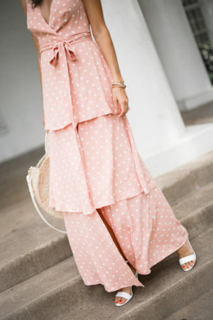 the miller affect wearing a pink polka dot maxi dress