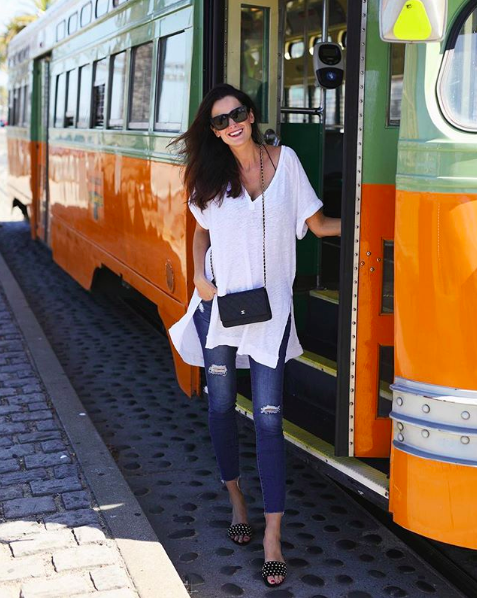 the miller affect wearing a white free people tunic tee