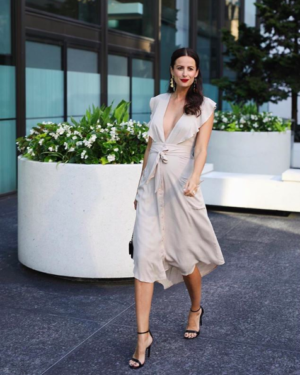 the miller affect wearing a beige plunge midi dress from Nordstrom