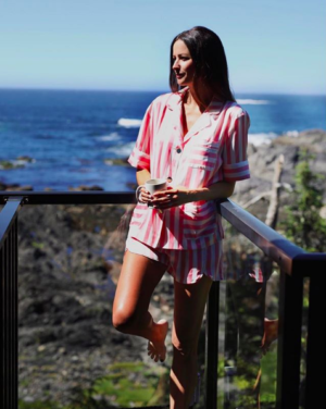the miller affect wearing pink stripe satin pajamas
