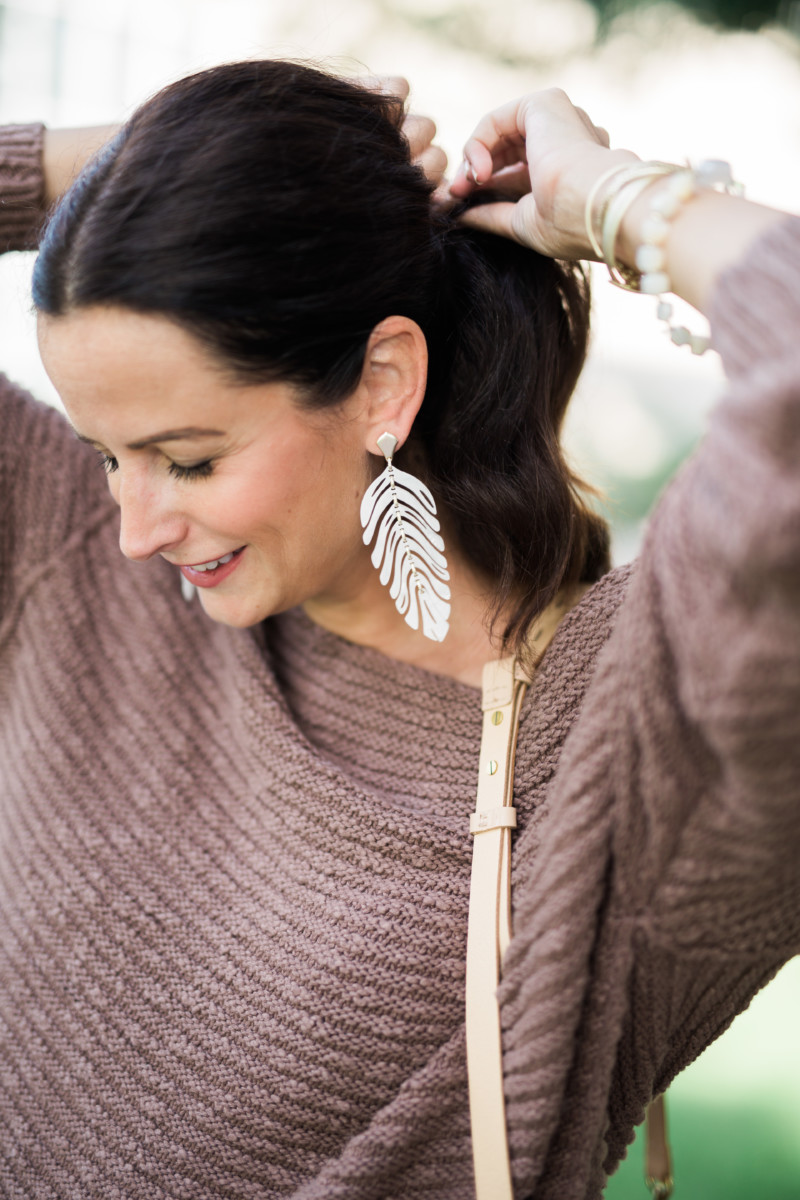 the miller affect wearing ivory acrylic lotus statement earrings