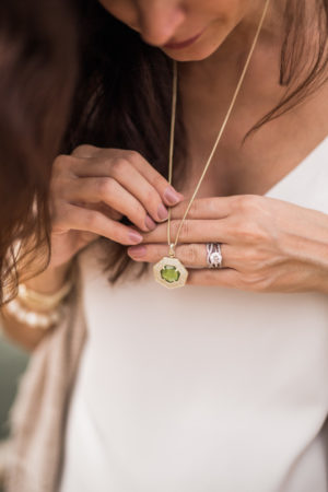 the miller affect wearing a peridot charm from Kendra scott