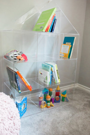 the miller affect with a crate and barrel acrylic bookshelf in her daughter's nursery