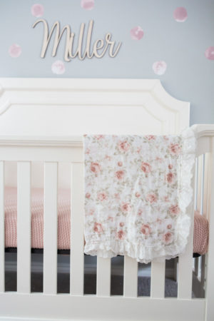 the miller affect with a newbie floral blanket on her crib