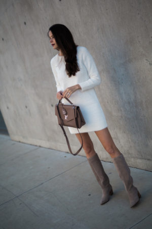 the miller affect wearing a white sweater dress from lou & grey