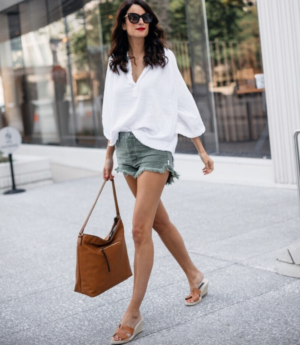 themilleraffect.com wearing a white top and olive denim shorts