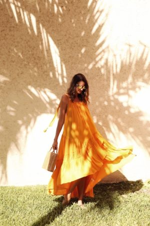themilleraffect.com wearing an orange maxi dress