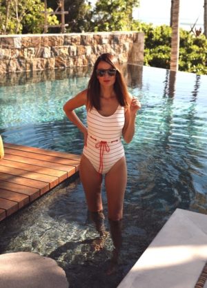the miller affect wearing a solid and striped swimsuit from nordstrom