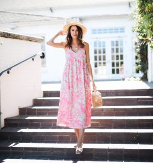 the miller affect wearing pink and blue palm print dress