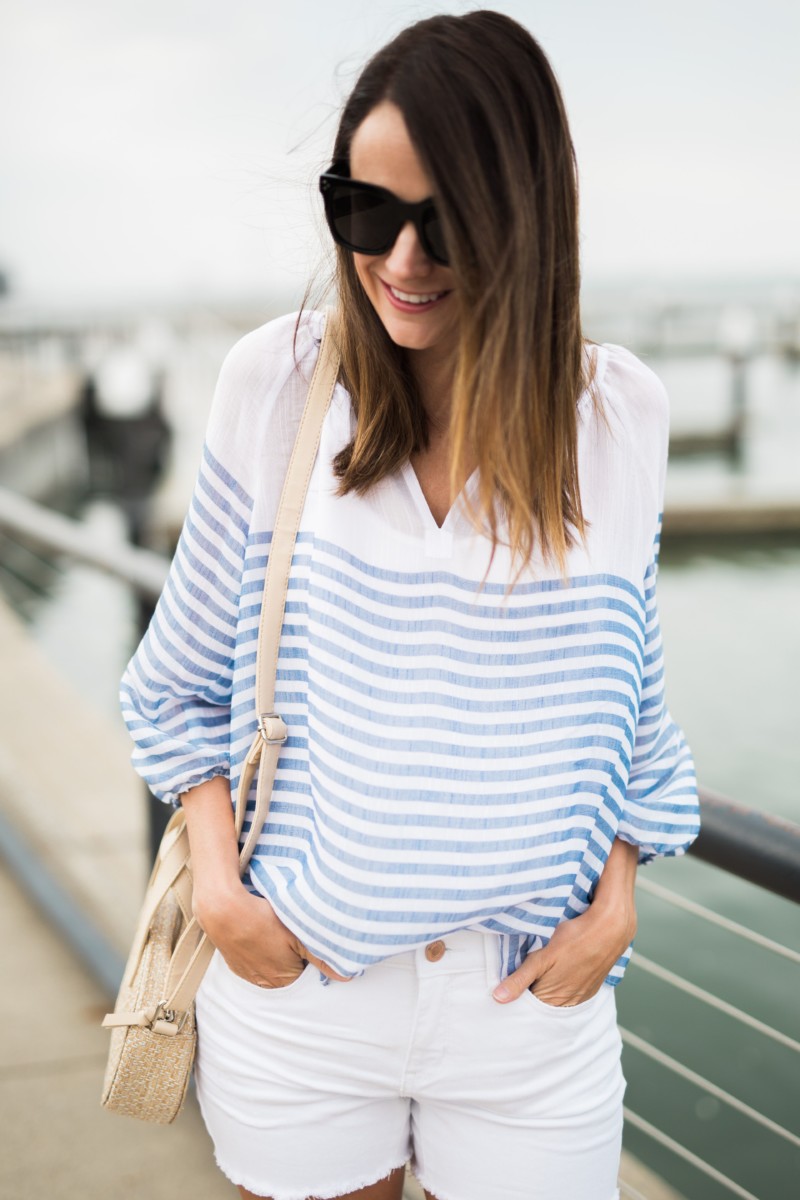 the miller affect wearing a blue and white stripe blouse