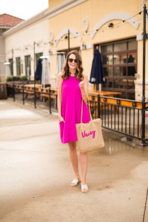 the miller affect wearing a hot pink dress and straw bag from walmart