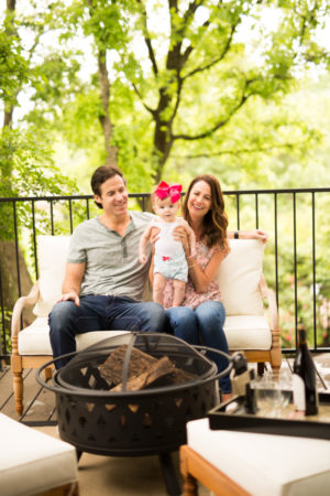 themilleraffect.com holding baby by stage iron fire pit