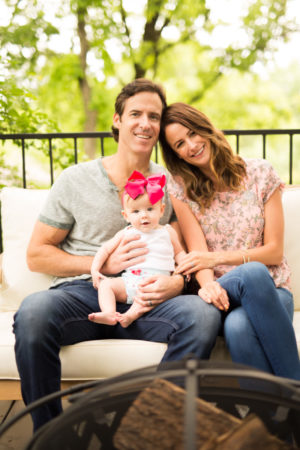 the miller affect with her husband and baby outdoors