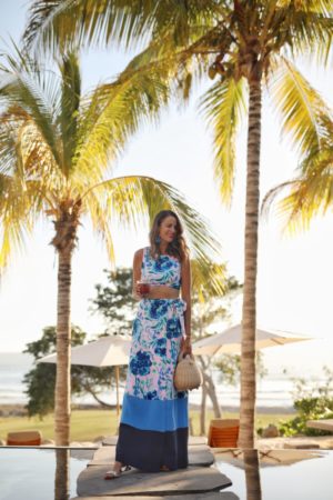 the miller affect wearing a blue floral lily pulitzer two-piece set