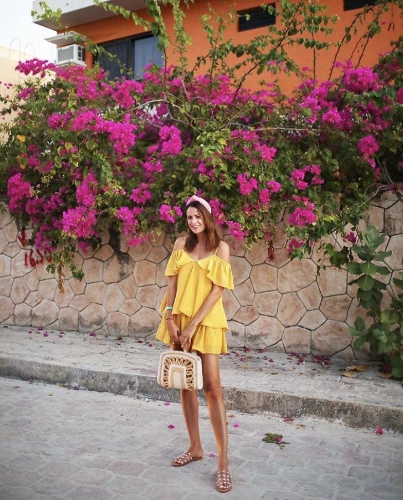 themilleraffect.com wearing a yellow ruffle dress and straw bag in mexico