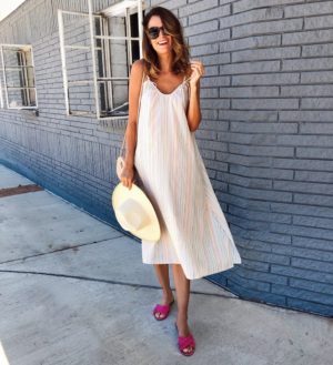the miller affect wearing a rainbow midi dress and madewell sunhat
