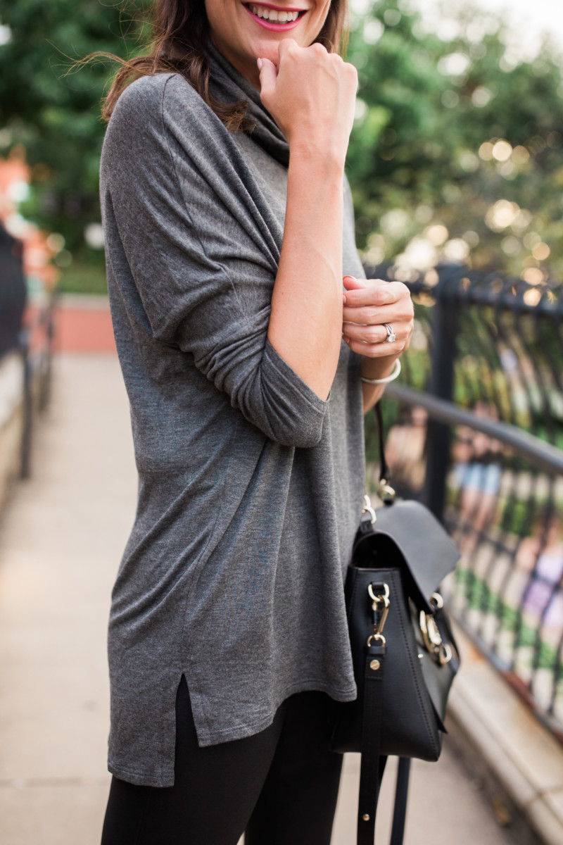the miller affect wearing a long grey tunic with leather leggings