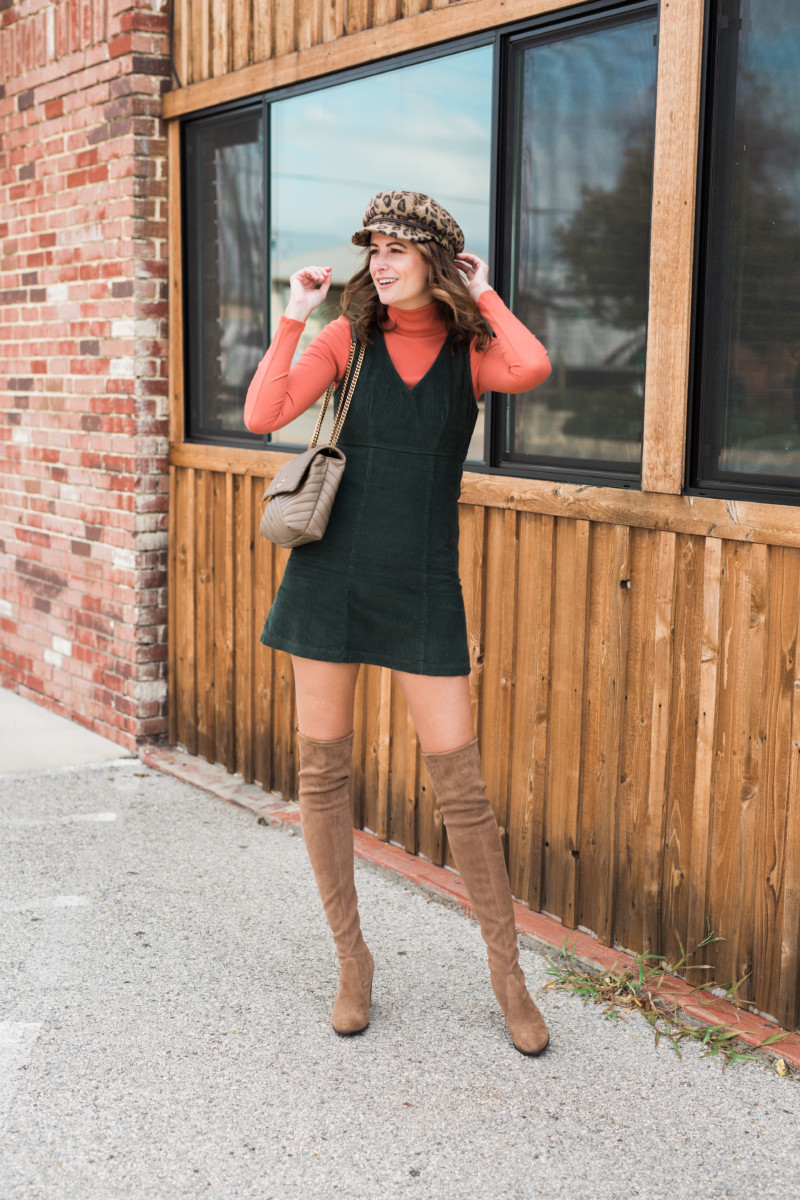 the miller affect wearing over the knee boots and a corduroy pinafore dress 