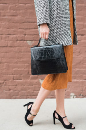 the miller affect carrying a black croc embossed tote from nordstrom