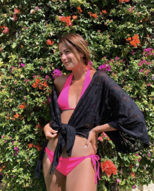 The Miller Affect wearing a pink bikini with a black kimono.