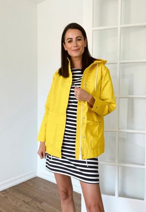 wearing a bright yellow raincoat from walmart on the blog themilleraffect.com