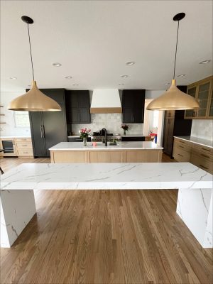 black and white kitchen with a double island on the miller affect